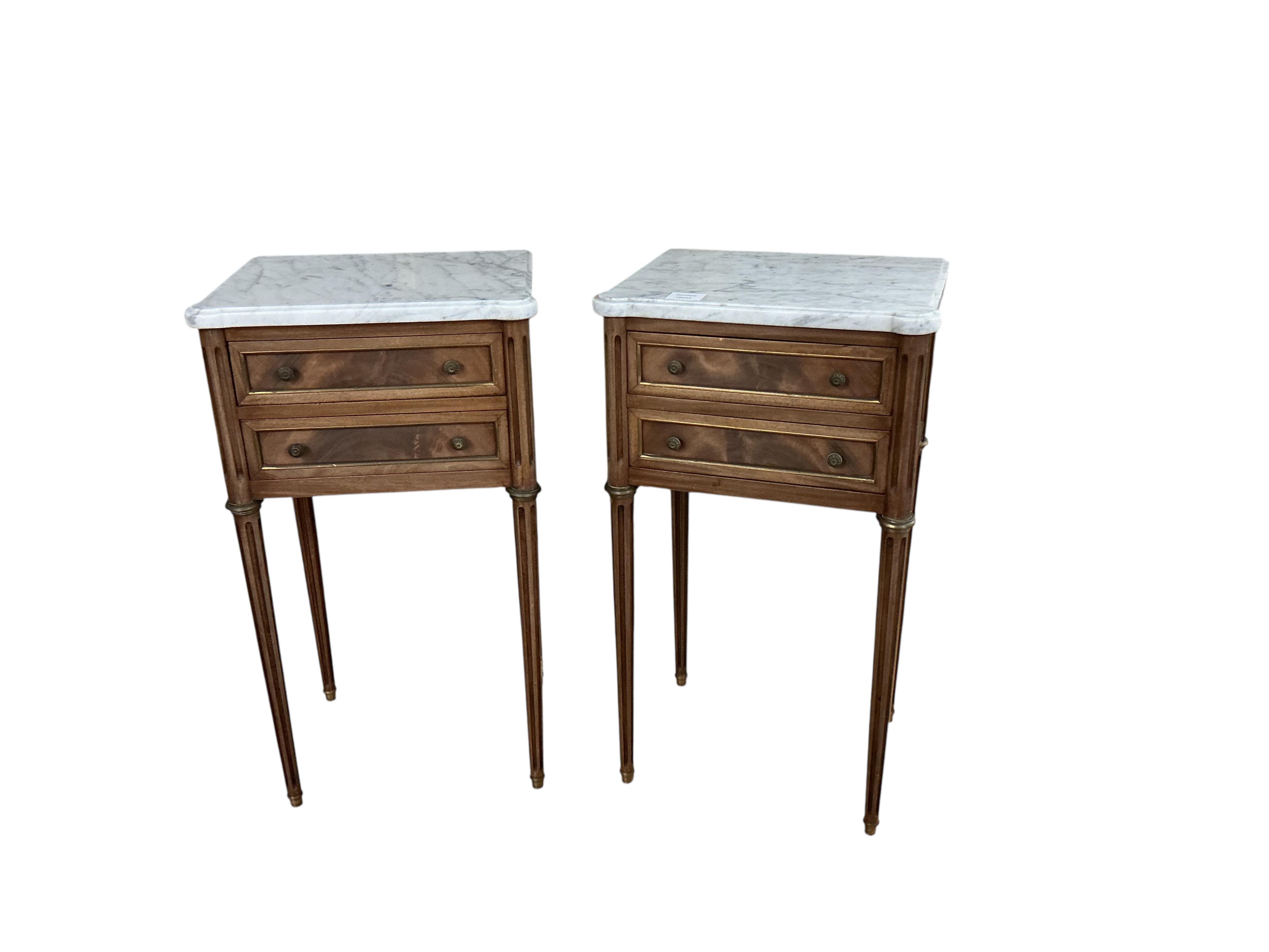 A pair of French brass mounted mahogany marble topped two drawer bedside chests, width 38cm, depth 30cm, height 68cm